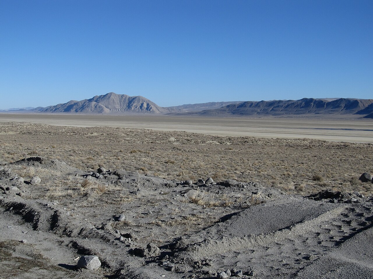 Shadeless desert terrain under a clear sky